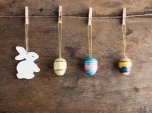 Rustic Easter background: Vintage painted eggs and white heart hang on clothespins against old wooden wall. Holiday concept stock photography Rustic Easter background: Vintage painted eggs and white heart hang on clothespins against old wooden wall. Holiday concept stock photography
