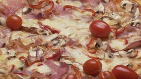 Rustic italian pizza with ham, kaiser, mozzarella and mushrooms stock video footage Rustic italian pizza with ham, kaiser, mozzarella and mushrooms stock video footage