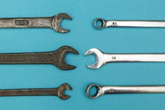 Rusty and shiny spanners on blue background stock images Rusty and shiny spanners on blue background stock images