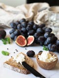 Rye bread and a knife with cream cheese and various fruits on a marble background. Cooking toast with cheese and berries. royalty free stock images Rye bread and a knife with cream cheese and various fruits on a marble background. Cooking toast with cheese and berries. royalty free stock images