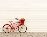 Rétro bicyclette rouge avec le panier et fleurs devant le mur blanc, fond
