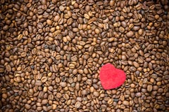 Röd hjärta på bakgrund för kaffebönor arkivbild Röd hjärta på bakgrund för kaffebönor arkivbild