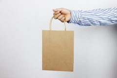 Ręka biznesmena mienia brązu papierowa torba zdjęcie stock Ręka biznesmena mienia brązu papierowa torba zdjęcie stock