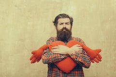 Sad bearded man hugging red heart shape toy with hands royalty free stock photos Sad bearded man hugging red heart shape toy with hands royalty free stock photos