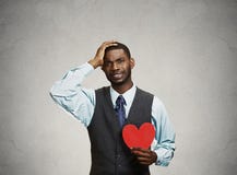 Sad company man holding red heart, crying stock photography Sad company man holding red heart, crying stock photography