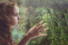 Sad curly little girl looking out the rain drop window Stock Images Sad curly little girl looking out the rain drop window Stock Images