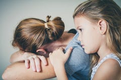 Sad daughter hugging his mother stock image Sad daughter hugging his mother stock image