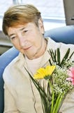 Sad elderly woman with flowers Royalty Free Stock Photos Sad elderly woman with flowers Royalty Free Stock Photos