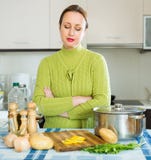 Sad female at kitchen Stock Photo Sad female at kitchen Stock Photo