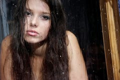 Sad Girl Behind Wet Window Stock Image