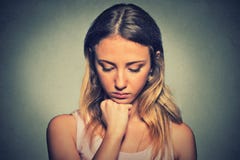 Sad woman on gray wall background Stock Photo Sad woman on gray wall background Stock Photo