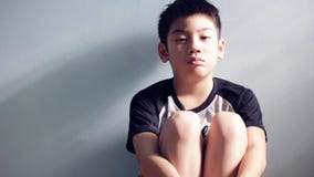 Sadness asian kid sit and depressed ,Tilt up camera stock video Sadness asian kid sit and depressed ,Tilt up camera stock video