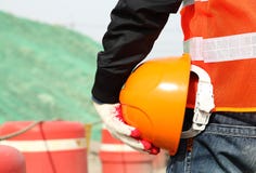 Safety work concept, construction worker holding helmet