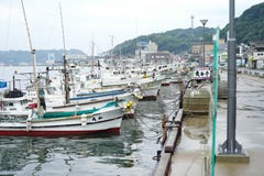Saga, Japan:September 1, 2016 - Landscape with group of fishing boat parking at the port with cityscape in background. Traditional royalty free stock photo Saga, Japan:September 1, 2016 - Landscape with group of fishing boat parking at the port with cityscape in background. Traditional royalty free stock photo