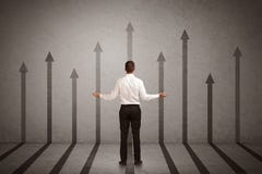 Sales Person Looking At Arrows Pointing Up On The Wall Concept Royalty Free Stock Photos Sales Person Looking At Arrows Pointing Up On The Wall Concept Royalty Free Stock Photos