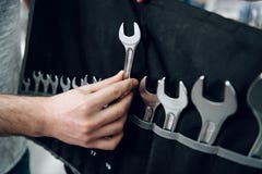 Salesman is showing bearded client set of wrenches in power tools store. royalty free stock images Salesman is showing bearded client set of wrenches in power tools store. royalty free stock images
