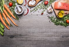 Salmon Fillet With Delicious Ingredients For Cooking A Variety Of Vegetables And Herbs, Salt In The Wooden Spoon, Cherry Tomatoes, Royalty Free Stock Photography Salmon Fillet With Delicious Ingredients For Cooking A Variety Of Vegetables And Herbs, Salt In The Wooden Spoon, Cherry Tomatoes, Royalty Free Stock Photography