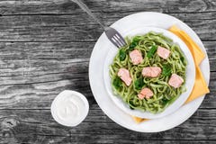 Salmon and Spinach Fettuccine pasta on white dishes stock image Salmon and Spinach Fettuccine pasta on white dishes stock image