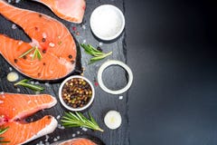 salmon steak, pepper and salt, herbs on black stone concrete table, copy space top view stock photo salmon steak, pepper and salt, herbs on black stone concrete table, copy space top view stock photo