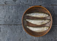 Salted herring in a clay bowl on wooden black table. The view from the top. Salted herring in a clay bowl on wooden rustic table. The view from the top. Natural Stock Images Salted herring in a clay bowl on wooden black table. The view from the top. Salted herring in a clay bowl on wooden rustic table. The view from the top. Natural Stock Images
