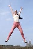 Salto alegre de la mujer joven Imagenes de archivo Salto alegre de la mujer joven Imagenes de archivo