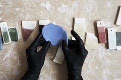 Samples of colored enamel for color ceramic in hands, working process in studio, clay, wood, craft. stock photo Samples of colored enamel for color ceramic in hands, working process in studio, clay, wood, craft. stock photo