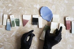 Samples of colored enamel for color ceramic in hands, working process in studio, clay, wood, craft. royalty free stock images Samples of colored enamel for color ceramic in hands, working process in studio, clay, wood, craft. royalty free stock images