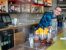 Bartender opens dish washer behind counter letting steam out royalty free stock photo Bartender opens dish washer behind counter letting steam out royalty free stock photo