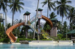 Water Slide Of Pool In a resort planted with coconut trees royalty free stock image Water Slide Of Pool In a resort planted with coconut trees royalty free stock image