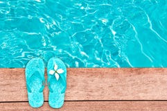 Sandals by a swimming pool, summer concept Royalty Free Stock Photography Sandals by a swimming pool, summer concept Royalty Free Stock Photography