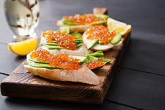 Sandwiches With Salmon Red Caviar With Sliced Avocado. Stock Images
