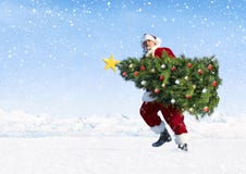 Santa Claus Carrying Christmas Tree on Snow royalty free stock image Santa Claus Carrying Christmas Tree on Snow royalty free stock image