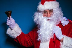 Santa Claus holding a bell in his right hand Stock Images Santa Claus holding a bell in his right hand Stock Images