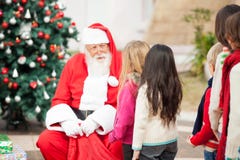 Santa Claus Looking At Children Standing in A royalty-vrije stock fotografie Santa Claus Looking At Children Standing in A royalty-vrije stock fotografie
