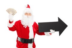 Santa Claus sonriente que sostiene la flecha negra que señala a la derecha y el dolla fotografía de archivo libre de regalías Santa Claus sonriente que sostiene la flecha negra que señala a la derecha y el dolla fotografía de archivo libre de regalías
