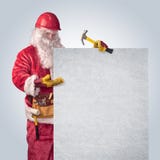 Santa Claus worker in helmet with poster stock image Santa Claus worker in helmet with poster stock image