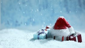 Santa hat and gifts in snow
