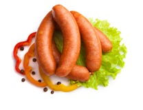Sausages with salad and paprika on a white background. royalty free stock photo Sausages with salad and paprika on a white background. royalty free stock photo