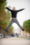 saut L'homme heureux enthousiaste sautant vers le haut de haut, port occasionnel vêtent Image stock saut L'homme heureux enthousiaste sautant vers le haut de haut, port occasionnel vêtent Image stock