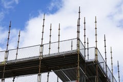 Scaffold platform and poles in blue sky at high level of construction building site royalty free stock photo Scaffold platform and poles in blue sky at high level of construction building site royalty free stock photo