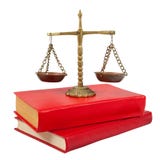 Scales of justice atop legal books