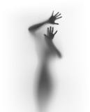 Scary human silhouette behind a diffuse surface
