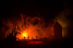 Scary view of zombies at cemetery dead tree, moon, church and spooky cloudy sky with fog, Horror Halloween concept