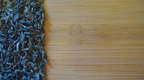Scattered green tea on wood bamboo background royalty free stock image Scattered green tea on wood bamboo background royalty free stock image