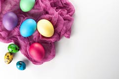 Scattered painted easter chicken and quail eggs on a white backg Royalty Free Stock Image Scattered painted easter chicken and quail eggs on a white backg Royalty Free Stock Image