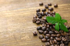 Scattered roasted coffee beans and leaves stock photos Scattered roasted coffee beans and leaves stock photos