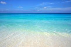 Scenic seascape of azure transparent ocean water and blue sky. Tropical beach with white sand. Idyllic scenery of seaside resort.