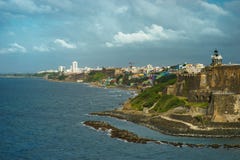 Scenic view of historic colorful Puerto Rico city in distance with fort in foreground royalty free stock image Scenic view of historic colorful Puerto Rico city in distance with fort in foreground royalty free stock image
