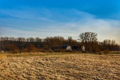 A field with a view of 2 old barns with lots of trees. Royalty Free Stock Photo A field with a view of 2 old barns with lots of trees. Royalty Free Stock Photo