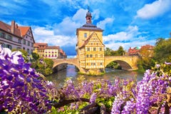 Scenic view of Old Town Hall of Bamberg Altes Rathaus with two bridges over the Regnitz river flower view